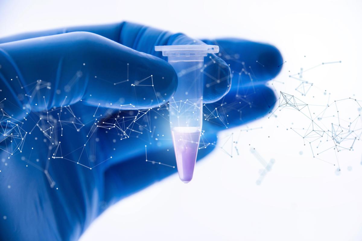 A hand wearing blue medical gloves holds up a small vial with an illustration of DNA superimposed on the image.