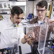 two students working on prototype in lab