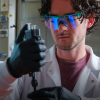 A man uses an injector in a bio lab