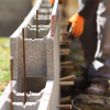 A worker places cement blocks