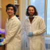 Two men in lab lab coats work in a laboratory
