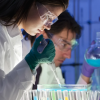 A man and a woman work in a lab