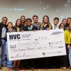 Team stands with giant prize check