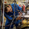 A man works on a complex machine
