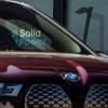 Closeup on a BMW vehicle with Solid Power logo in background