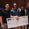 Winning team poses with a giant check