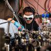 Man in white goggles works on a complicated machine