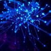 Fiber optic cables glowing in a dark space
