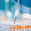 Pipette dripping orange liquid