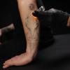 Tattoo fading and revealing on someone's forearm