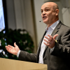 Man gives a speech from a podium