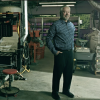 A man stands in a factory manufacturing cinder blocks