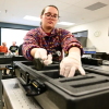 A student places equipment in a box