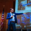 Man on stage giving presentation