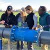 People working on a large water pipe