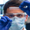 Man examines a vial in a lab