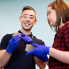 Engineer in the lab shows student a new building material