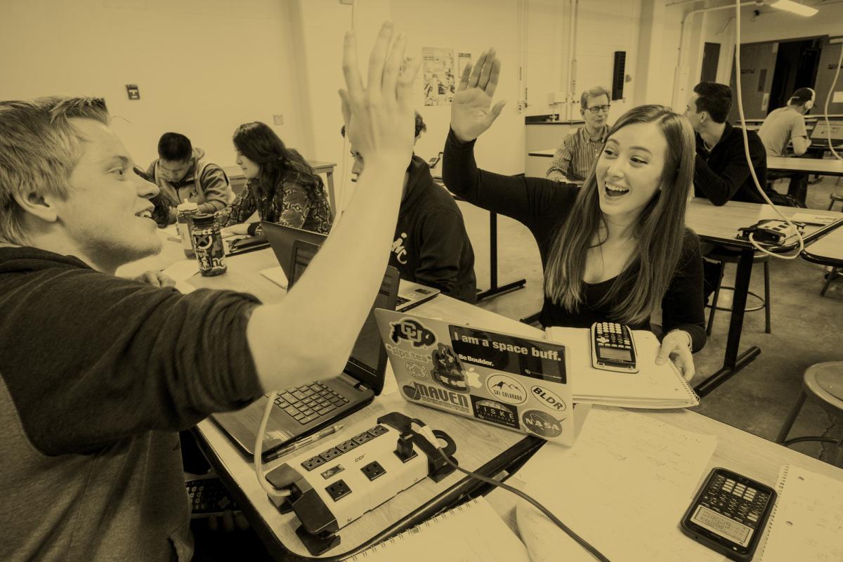 Students high-fiving in a classroom