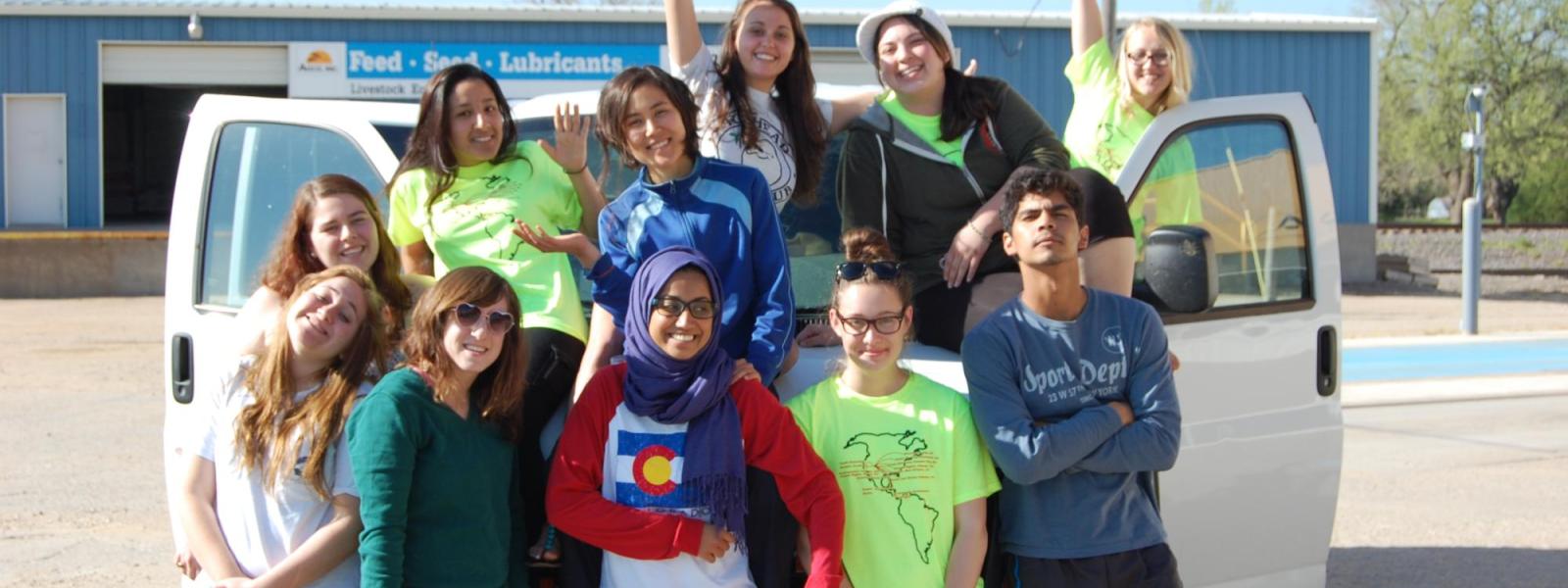 AB Participants pose in front of van