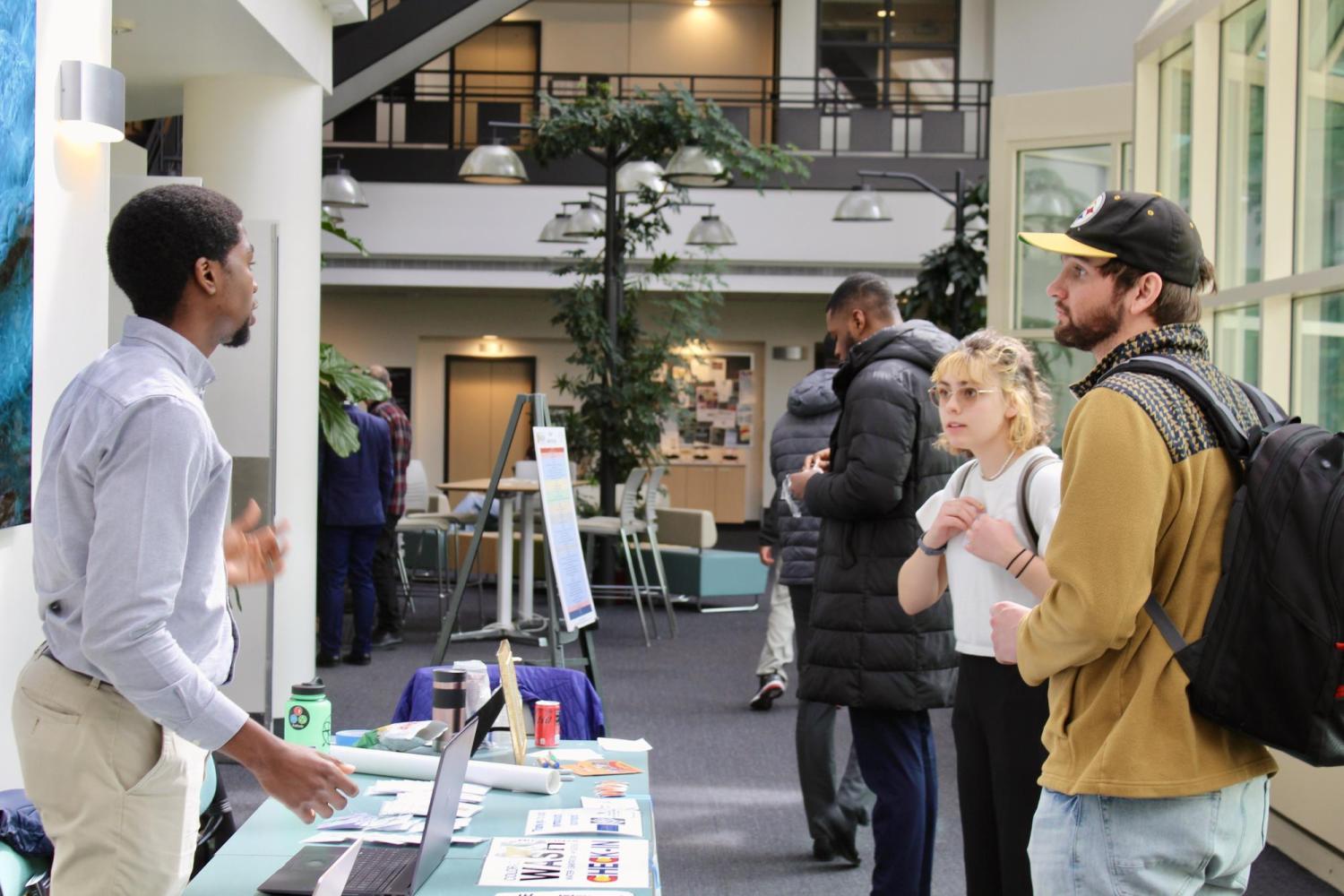 a group of conference goers asking someone for help