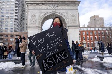 A woman holds a sign at the End The Violence Towards Asians rally in Washington Square Park on Feb. 20, 2021, in New York.Ron Adar/SOPA Images / Sipa USA via AP file